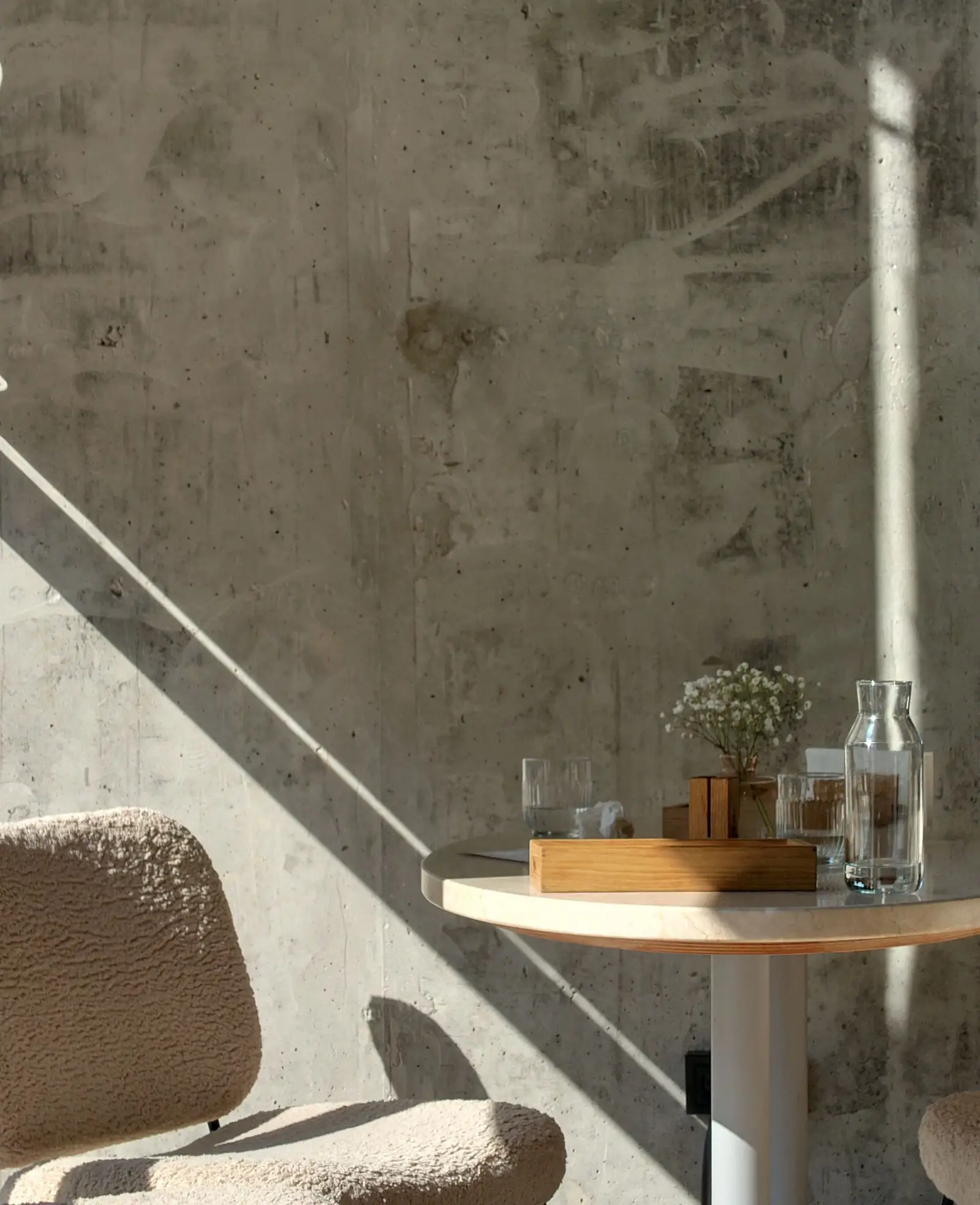 Daylight across a concrete stair and a quiet reading corner