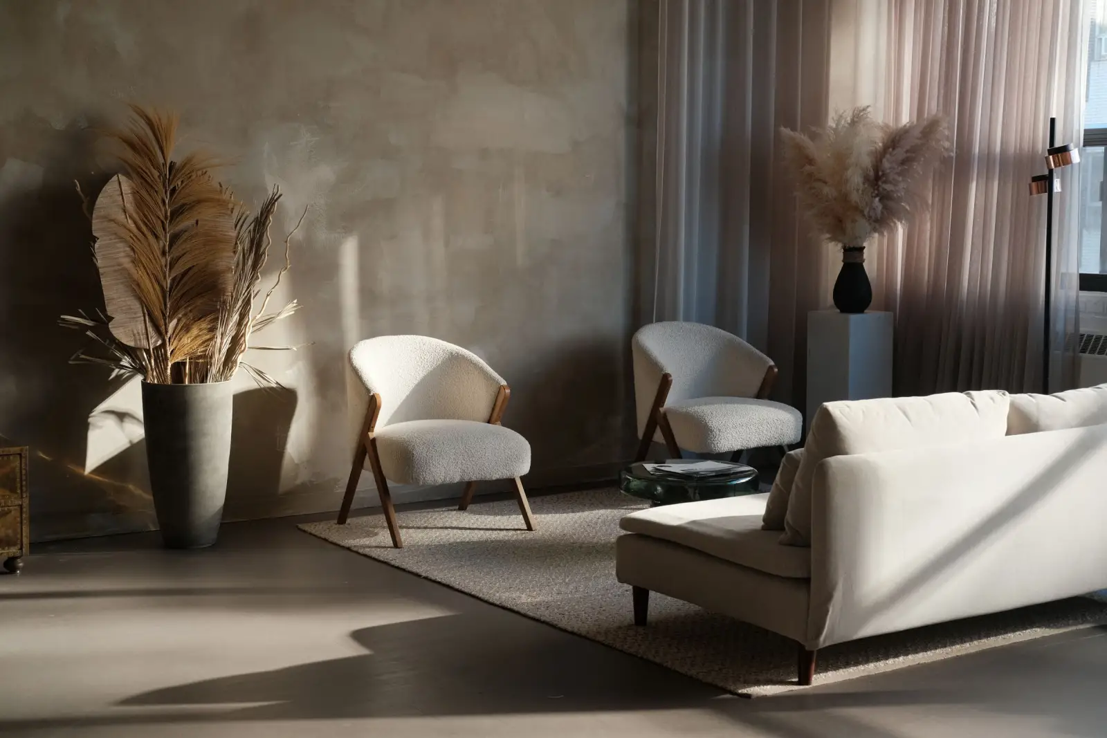 Warm, minimal living room with plaster walls and soft natural light